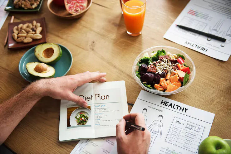 Shopping list on paper next to reusable bags